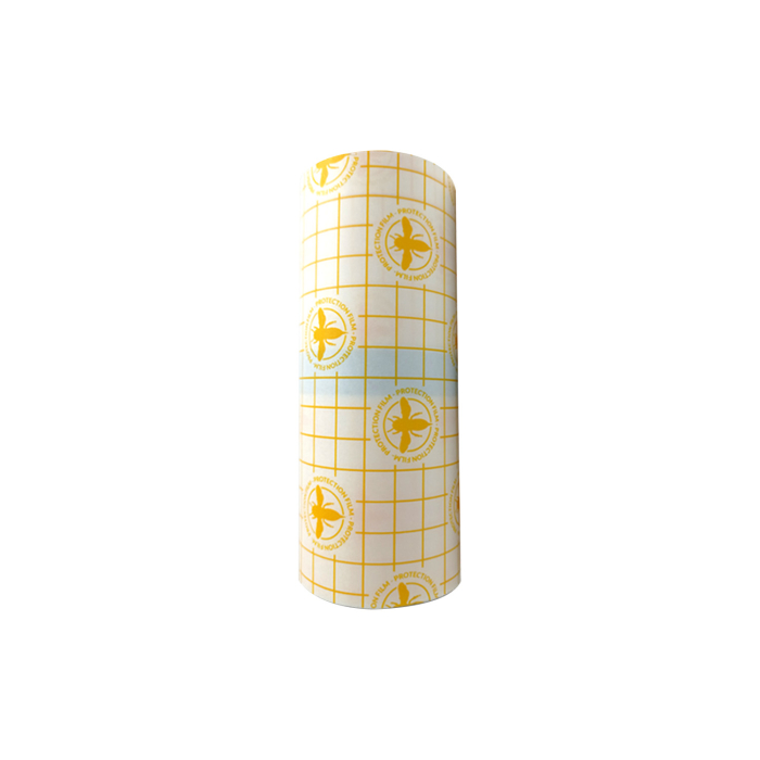 Un rouleau de « Hornet Film protecteur pour tatouage (15 cm x 10 m) » avec une grille jaune et des logos circulaires, présenté sur un fond blanc.